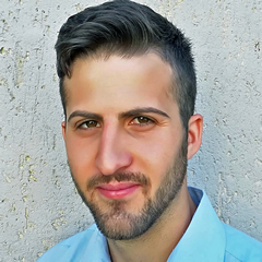 A person smiling for the camera  Description automatically generated with medium confidence